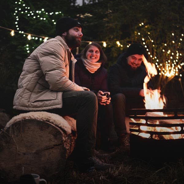 Three people sitting on a sledge in the snow